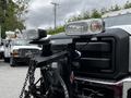 A 2011 Ford F-550 truck with mounted lights and a front plow attachment showcasing its rugged design and functionality