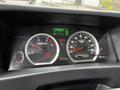 Dash of a 2018 Isuzu NPR showing speedometer and tachometer with various warning lights and digital displays