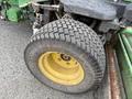 A close-up of a tire from a 2009 John Deere 2653B Precision Diesel Mower featuring a textured rubber surface and a yellow rim