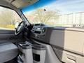Interior view of a 2023 Ford E-450 showing dashboard controls and center console with cup holders