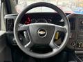 Steering wheel of a 2020 Chevrolet Express with the Chevrolet logo in the center and control buttons on the side