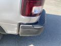 A silver 2021 RAM 1500 truck with a scratched rear bumper and distinctive tail light design