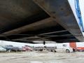 A 2011 Freightliner Cascadia Nordic truck viewed from underneath showing the chassis and wheel assembly