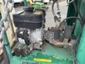 Close-up of a 2011 Hightliner Aquacide Hot Water Weed Control trailer's engine with various components including a black air filter and pressure gauge