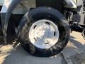 Close-up of a tire on a 2007 International 7300 featuring a white rim and black tread design