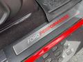 A close-up of a metal door sill plate from a 2019 Ford F-150 featuring the logo Ford Performance in bold red letters