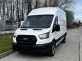 A 2020 Ford Transit van with a white exterior and black detailing parked in a clear area