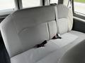 A gray fabric bench seat from a 2014 Ford Econoline with seat belts attached