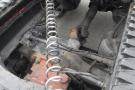 Close-up of the engine components of a 2015 Kenworth T660 showcasing pipes wires and mechanical parts