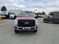 A red 2011 Ford F-250 SD facing forward with a black grille and visible headlights