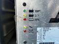 A control panel displaying battery charge levels with three colored lights: green for 100% yellow for 60% and red for 25% along with a manufacturer's label and specifications