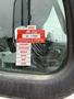 A red and white certificate of approval sticker displayed on the window of a 2012 Freightliner M2 112 truck showing months of the year from January to June