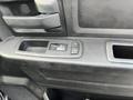 Interior panel of a 2015 RAM 1500 showing the window control and locking buttons on the armrest