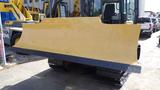 2013 Komatsu D37PX-22 bulldozer blade in yellow with a wide curved edge designed for pushing material and clearing surfaces