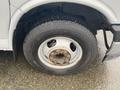 A close-up of a wheel from a 2018 Chevrolet Express showing a silver rim and a Michelin tire with visible tread and some wear on the rim