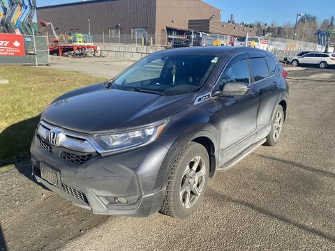 A 2019 Honda CR-V is parked with a dark gray exterior and sleek design featuring alloy wheels and tinted windows