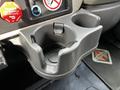 A gray cup holder designed for a 2008 International 7500 truck featuring two compartments for drinks and a circular base in the center