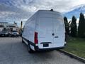 A white 2022 Mercedes-Benz Sprinter van parked displaying a sleek rear design with no visible branding or windows on the back doors