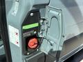 Close-up of a 2019 Mercedes-Benz Sprinter fuel filler cap with a red diesel nozzle inserted and warning labels on the side