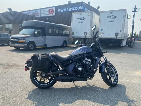 A 2020 Kawasaki Vulcan S motorcycle with a black bag on the side is parked on a paved surface