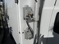 A close-up of an electrical connection box mounted on the side of a 2015 Ford F-550 with wires and connectors visible