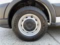 A close-up of a tire from a 2022 Ford Transit featuring a GoodYear Wrangler tread design and a steel wheel with a silver rim