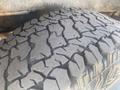 Close-up of a rugged tire with deep treads from a 2009 Ford Econoline showing detailed patterns designed for traction and durability