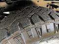 Close-up of a robust tire from a 2020 Ford F-350 showcasing deep treads designed for traction and durability