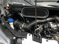 Close-up of the engine compartment of a 2022 Ford Transit showing the air intake system and various engine components including hoses and a reservoir