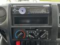 The dashboard display of a 2018 Hino 195 featuring a car stereo system and climate control knobs