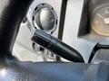 Close-up of the turn signal lever on the steering column of a 2016 Ford F-750