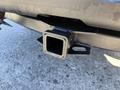 A black trailer hitch receiver on a 2014 Ford F-250 SD showing its rectangular opening and mounting holes