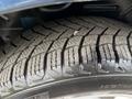 Close-up of a tire tread on a 2013 Dodge Journey showing detailed patterns for traction and grip