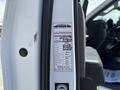 2020 Chevrolet Silverado with a service sticker displayed on the driver's side door detailing maintenance history and mileage