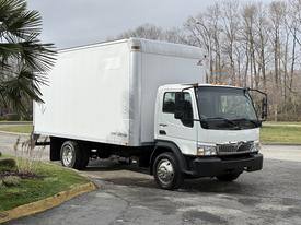 A 2008 International CityStar truck with a white box body and a cab showing a black grille and headlights parked in a driveway