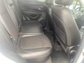 Interior view of the backseat of a 2018 Buick Encore featuring two black leather seats and a center armrest