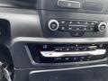 Interior dashboard controls of a 2021 Ford Explorer featuring audio and climate control buttons and a digital display
