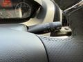 A close-up of the steering wheel and control stalk of a 2021 RAM Promaster showing the wiper control and dashboard indicators