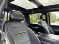 Interior of a 2019 Ford F-150 Raptor featuring leather seats with Raptor branding and a panoramic sunroof