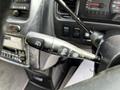 A close-up of the control lever inside a 2003 Mitsubishi 7 Passenger Van showing symbols for battery and windshield wipers