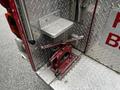 A vintage 1991 Sutphen Deluge with a red hydraulic pump handle prominently displayed on a diamond plate surface