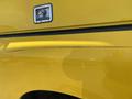 A 2015 RAM 1500 truck with a yellow exterior featuring a visible scratch along the side panel and a door handle on the rear section of the vehicle