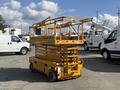 A yellow 2013 Haulotte Compact 3947E scissor lift with extended platform and safety guardrails