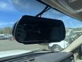 A rearview mirror display mounted in a 2013 Ford Expedition showing digital information