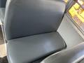 A close-up of a dark gray seat from a 2007 Blue Bird Vision school bus showing the seat's smooth surface and minimalist design