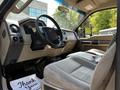 Interior view of a 2008 Ford F-550 showing the steering wheel driver's seat and floor mat with a message printed on it