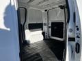 Interior view of a 2017 Nissan NV200 showing the empty cargo space with black flooring and white walls