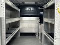 Interior of a 2019 Mercedes-Benz Metris with metal shelving units and storage compartments on both sides