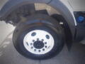 Close-up of a 2016 International WorkStar 7500 truck wheel with a white rim and black tire showing tread and bolts