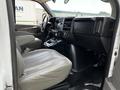 Interior view of a 2013 Chevrolet Express showing the driver's seat dashboard and center console with controls and storage compartments